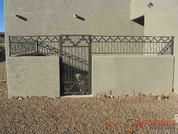 Short wall-mounted wrought iron fence and gate with southwestern motif IF213