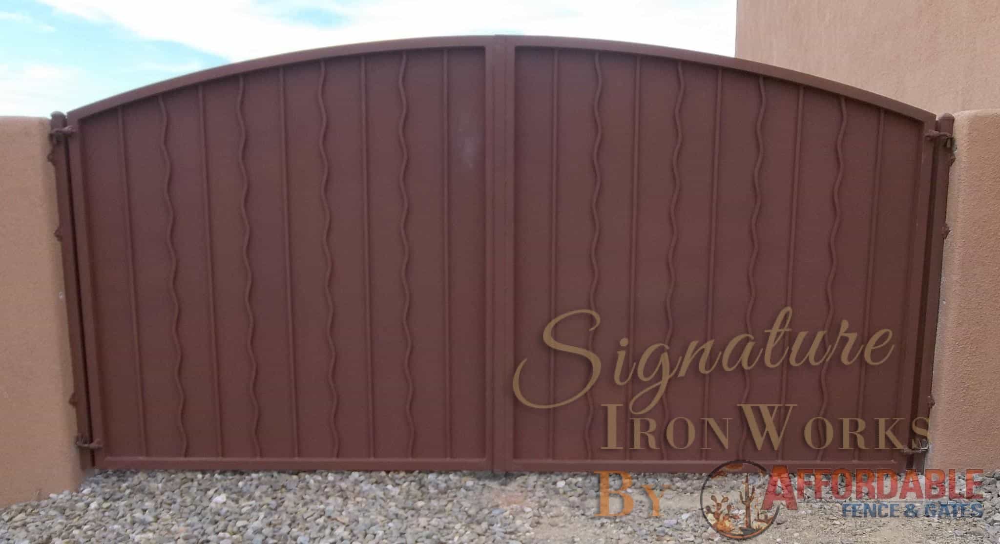 Arched top wrought iron gate with alternate wavy pattern and metal backing Tucson IG013