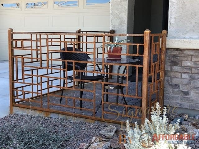 Iron fence with rust patina and a geometric motif creating a small enclosed patio 1696 - Installed in Tucson