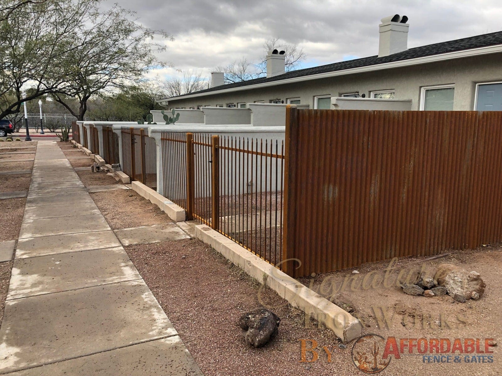 Rust iron fence with corrugated iron fence 2143 - new housing development in downtown Tucson