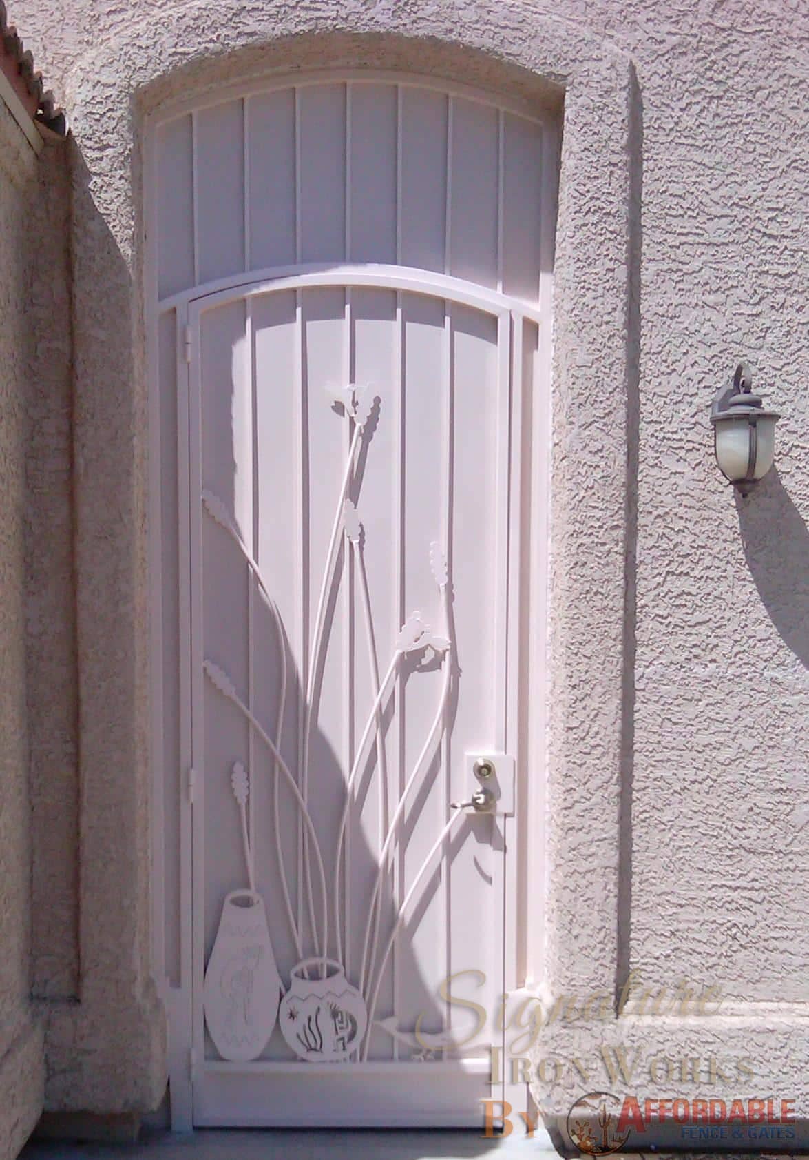Security door with ocotillo and hummingbird cutouts - Painted white 6016 E - Installed in Tucson