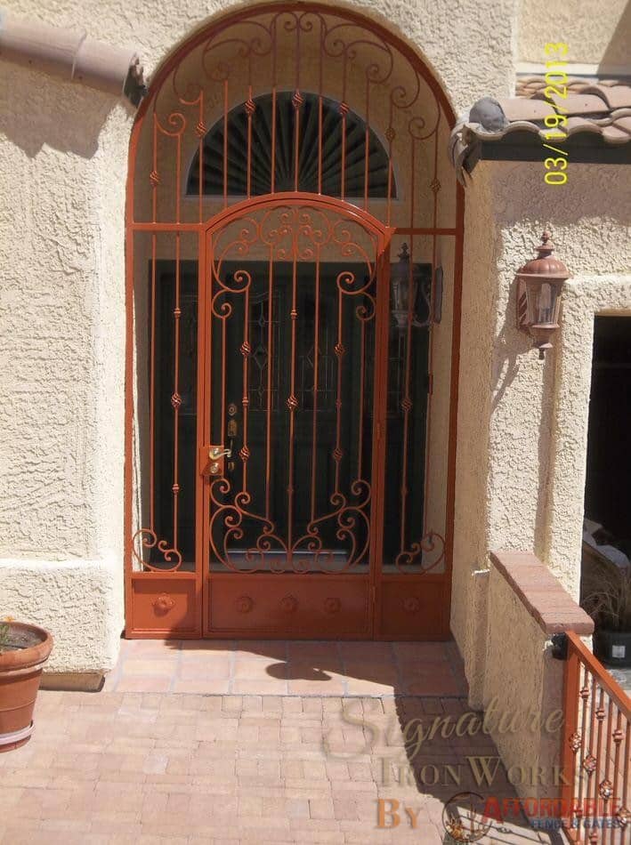 Security enclosure with scrolls and knuckles and decorative floral motifs on kick panels 7008 E - Installed in Tucson