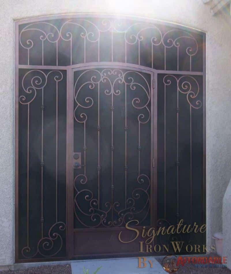 Iron security enclosure with arched security door ornamented with swirls and knuckles - Diamond ornements on bottom plate - 7007 E - Made in Tucson