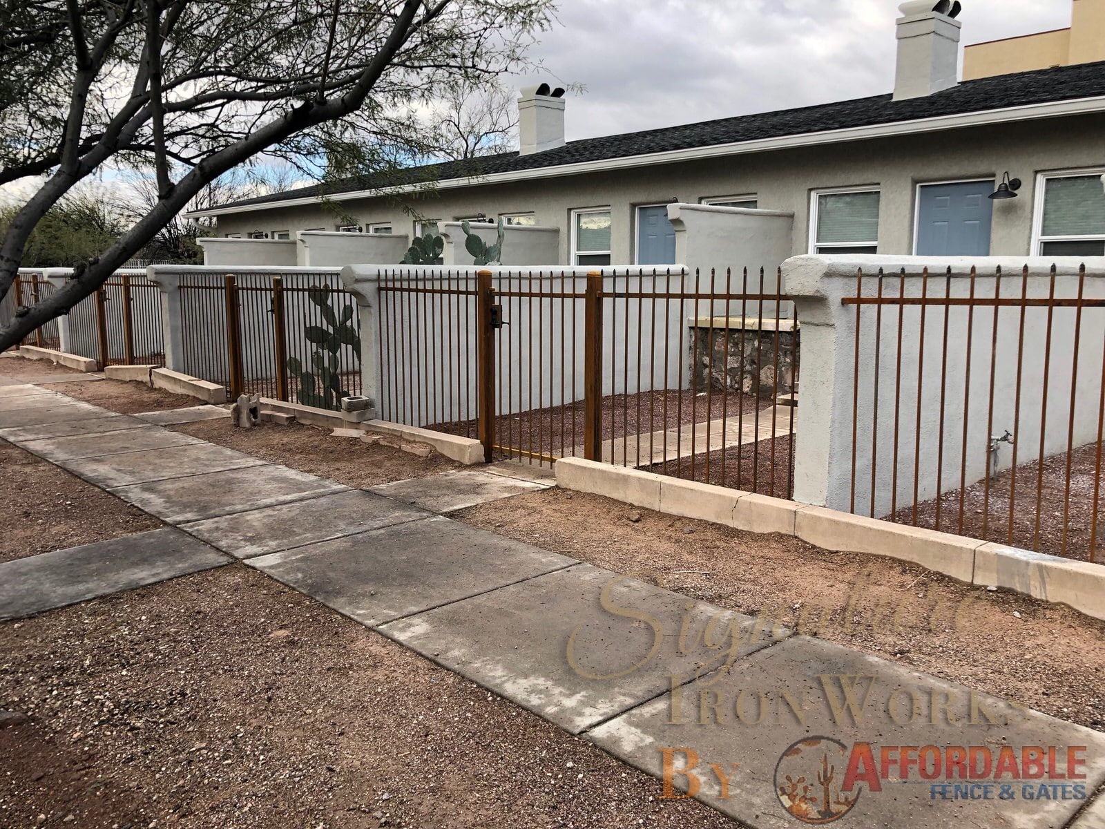 Wrought iron fence with rust patina 2145 - View fence and gates - New housing development