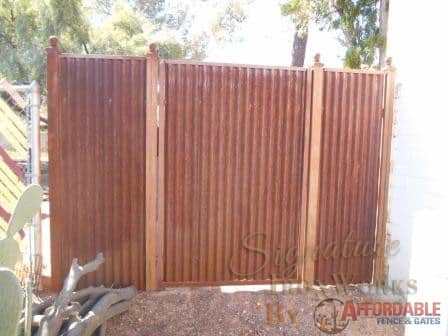 Affordable Fence & Gates | Signature Ironworks | Corrugated Steel Gate | Rusty Corrugated Steel Gate | Natural Rust Corrugated Steel Gate | Arch | Window Detail | Natural Rust Color