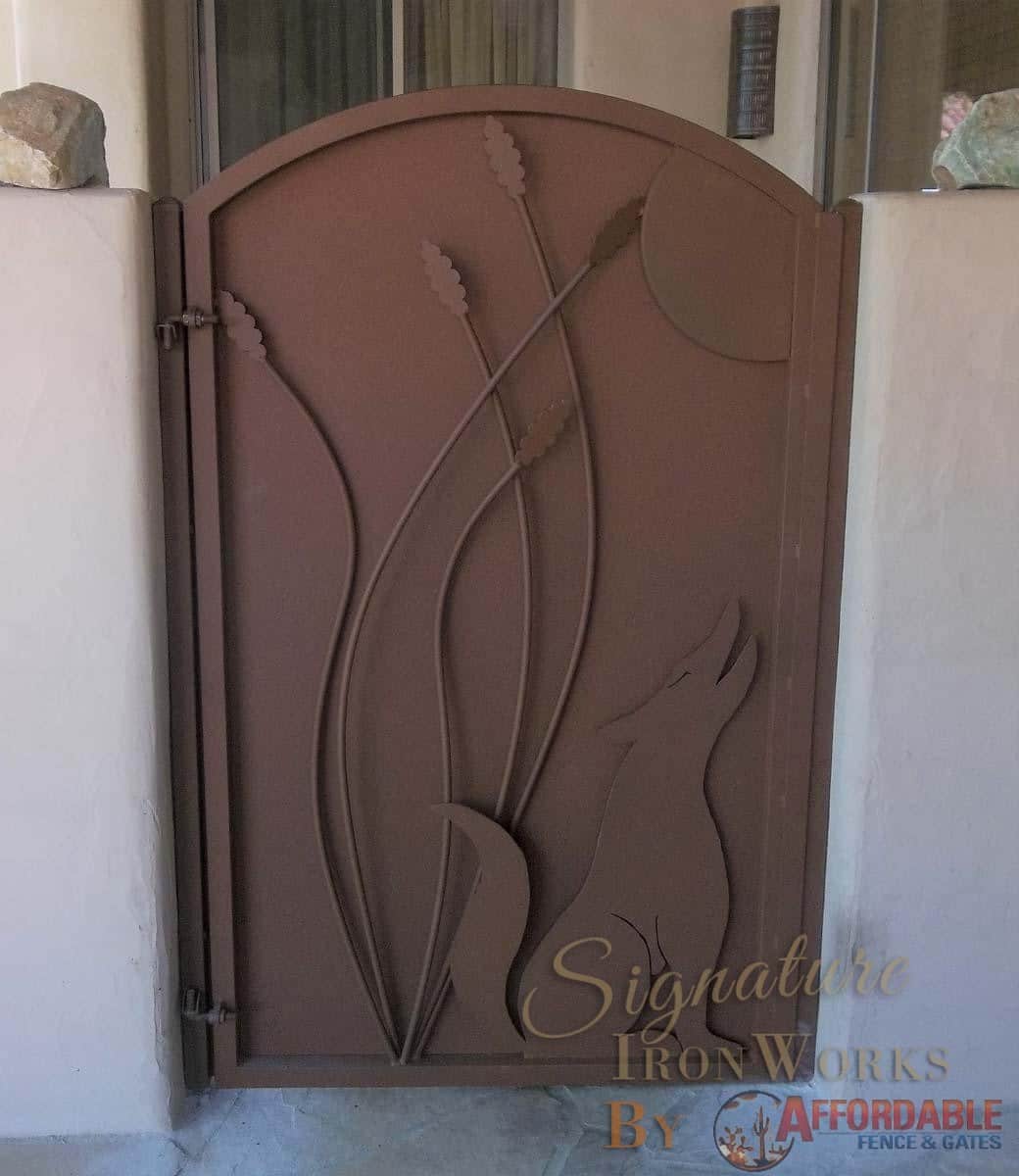 Arched-top wrought iron courtyard gate with metal plate backing and decorative cutouts (wolf, ocotillo) - Rust finish - Made in Tucson 100 0772