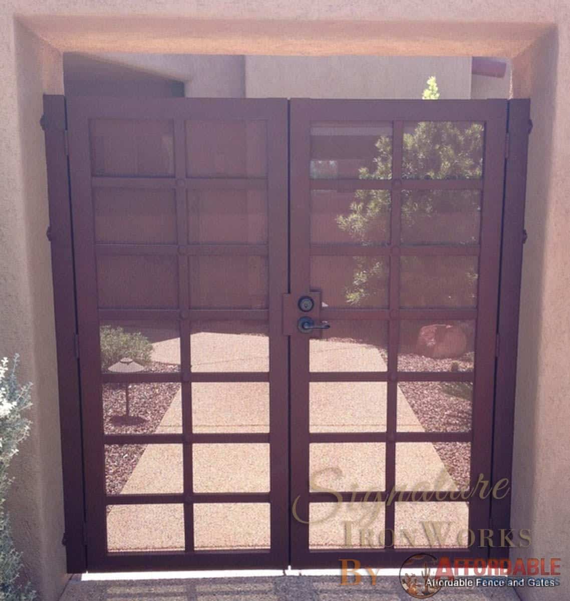 Double wrought iron gate with lattice structure, metal backing, lock and decorative clavos 001 - Installed in Tucson