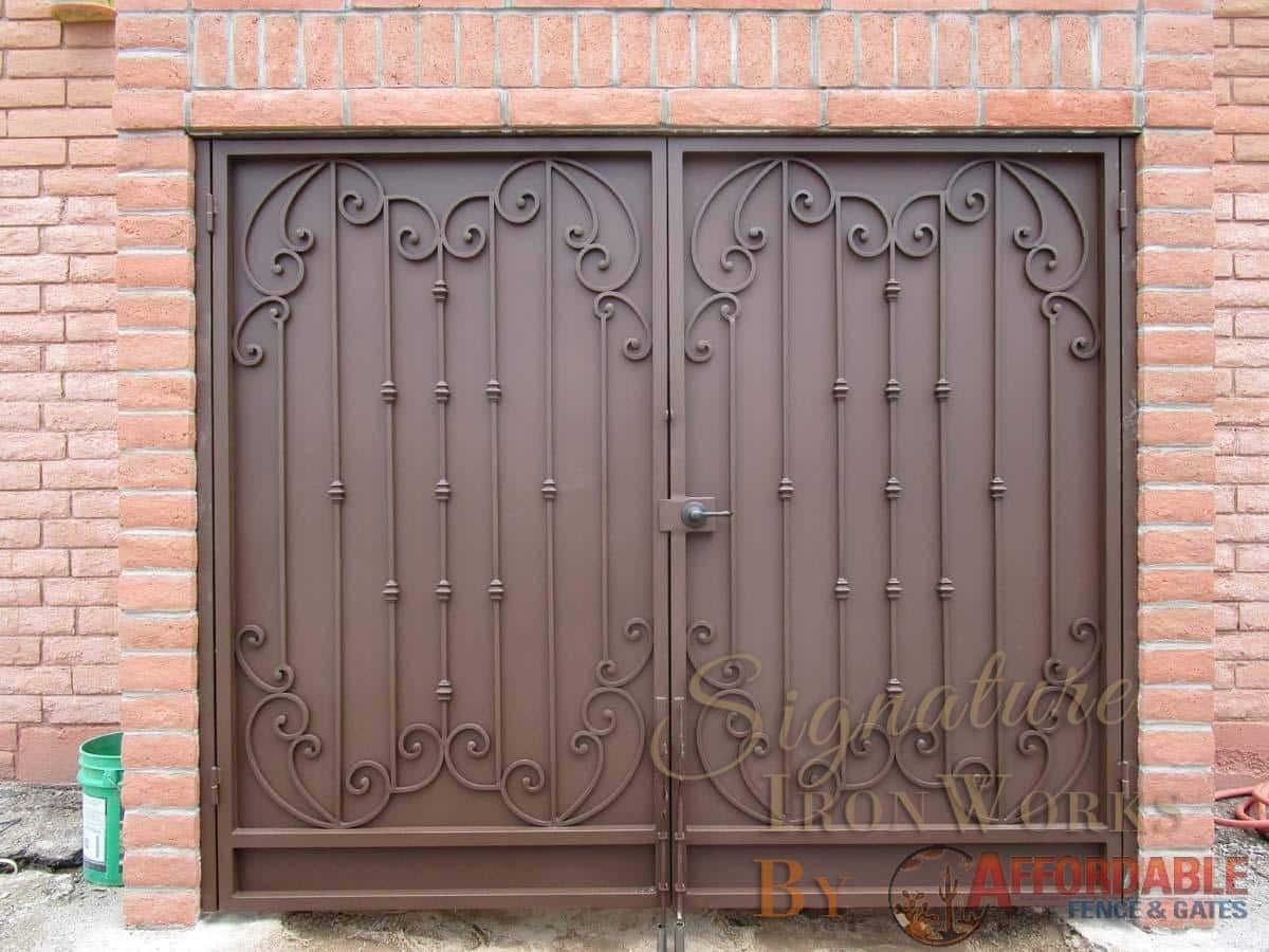 Double wrought iron security door with scroll work, knuckles on pickets and metal backing plate 900 IG